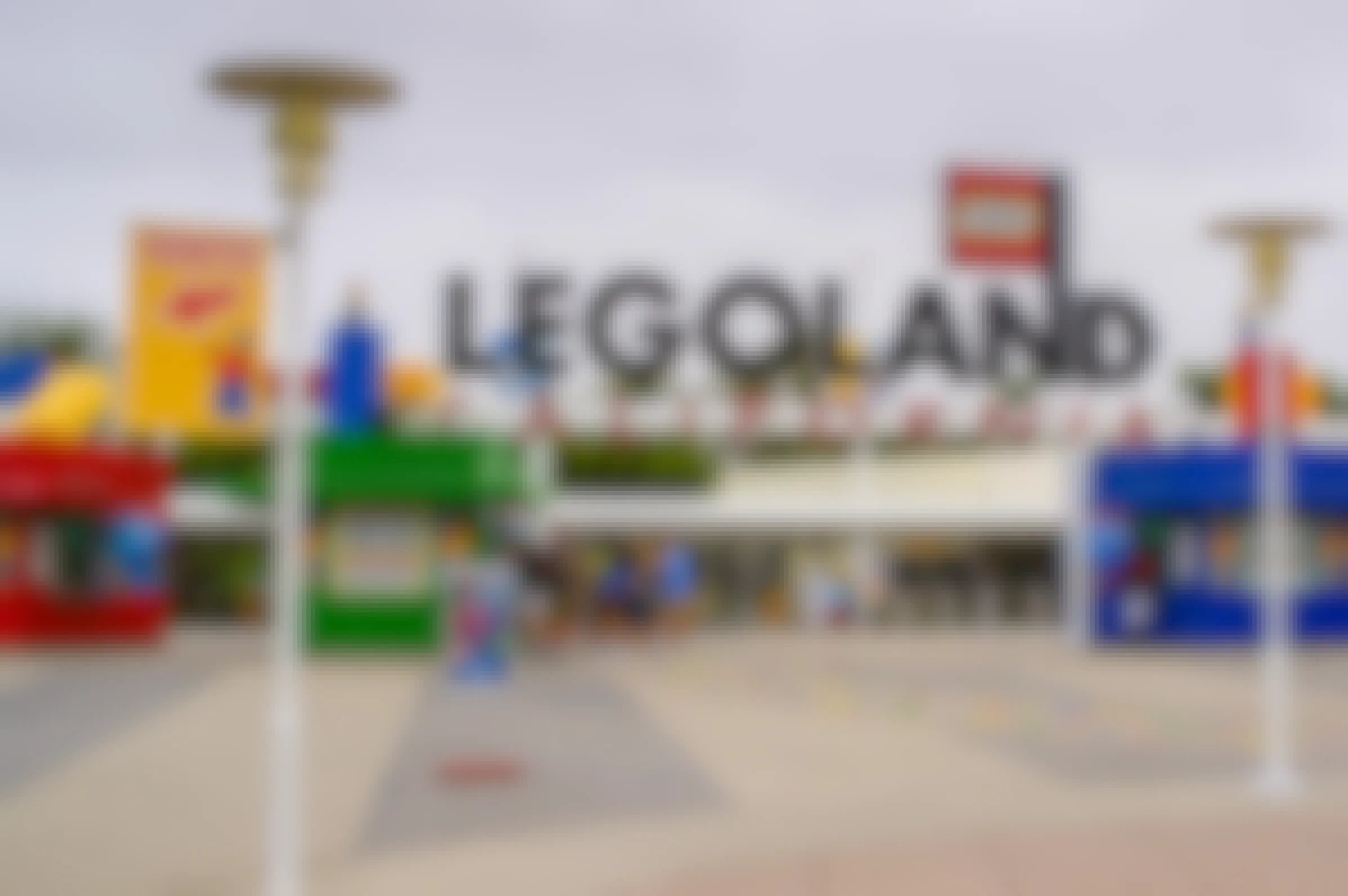 the entrance to LEGOLAND California with visitors waiting in line at one of the ticket booths