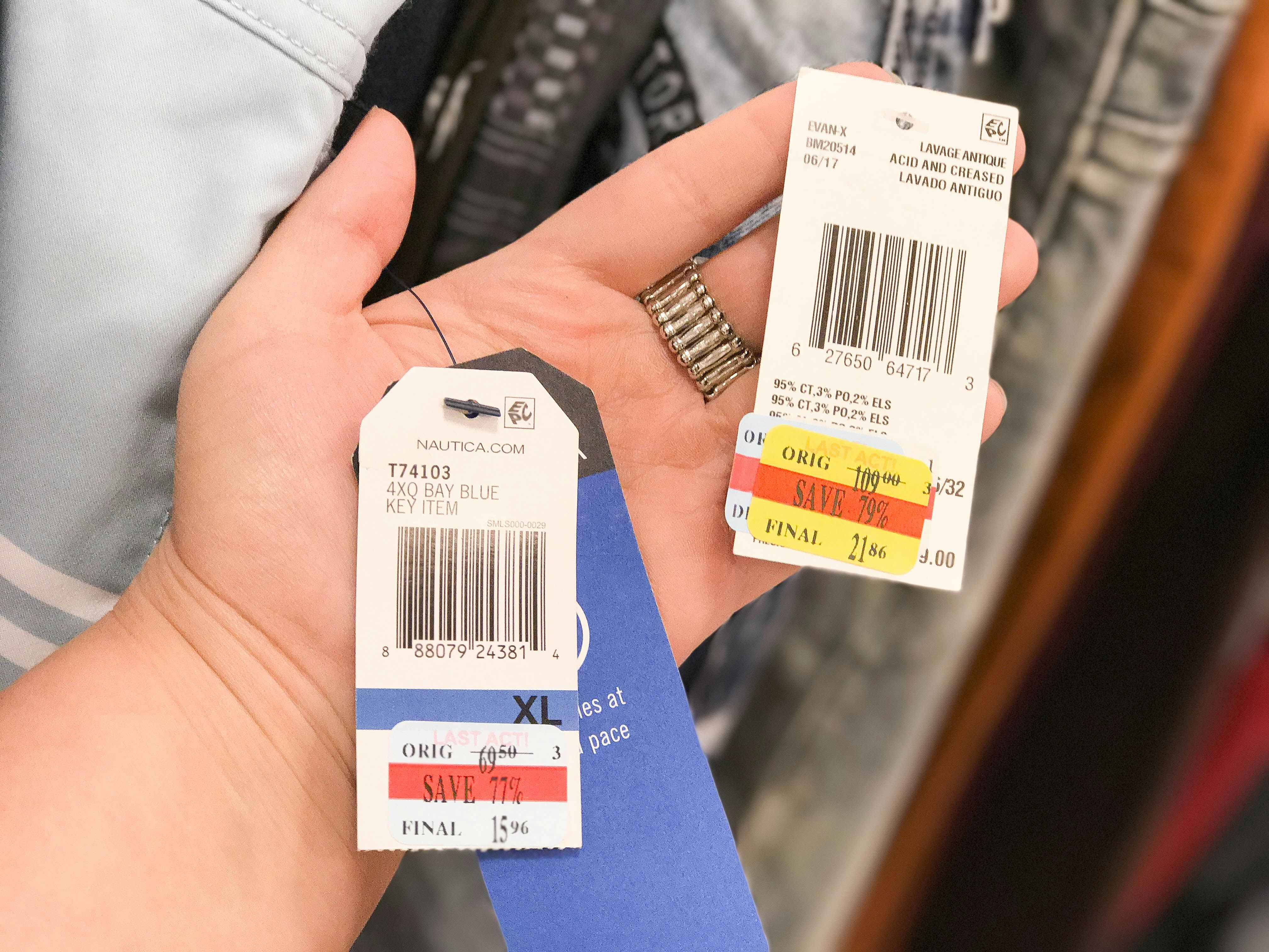 someone holding two price tags
