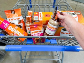 A Walmart shopping cart basket full of the different Dunkin brand items that are available at Walmart.
