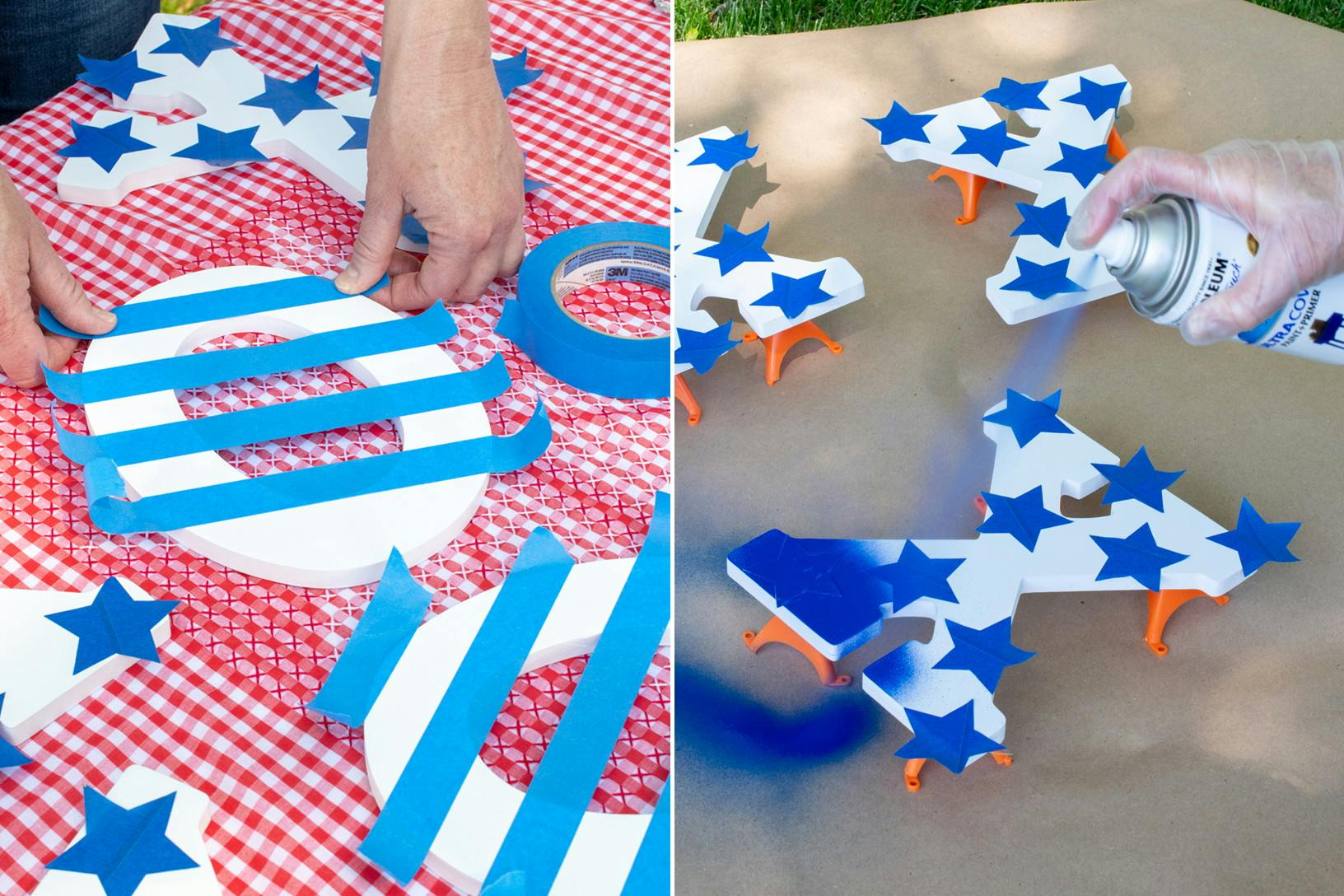 A person placing painters tape in a stripe pattern on a wooden O next to another striped O and some Xs with painters tape stars stuck on them. And a person using blue spray paint on the wooden Xs sitting on cardboard outside.