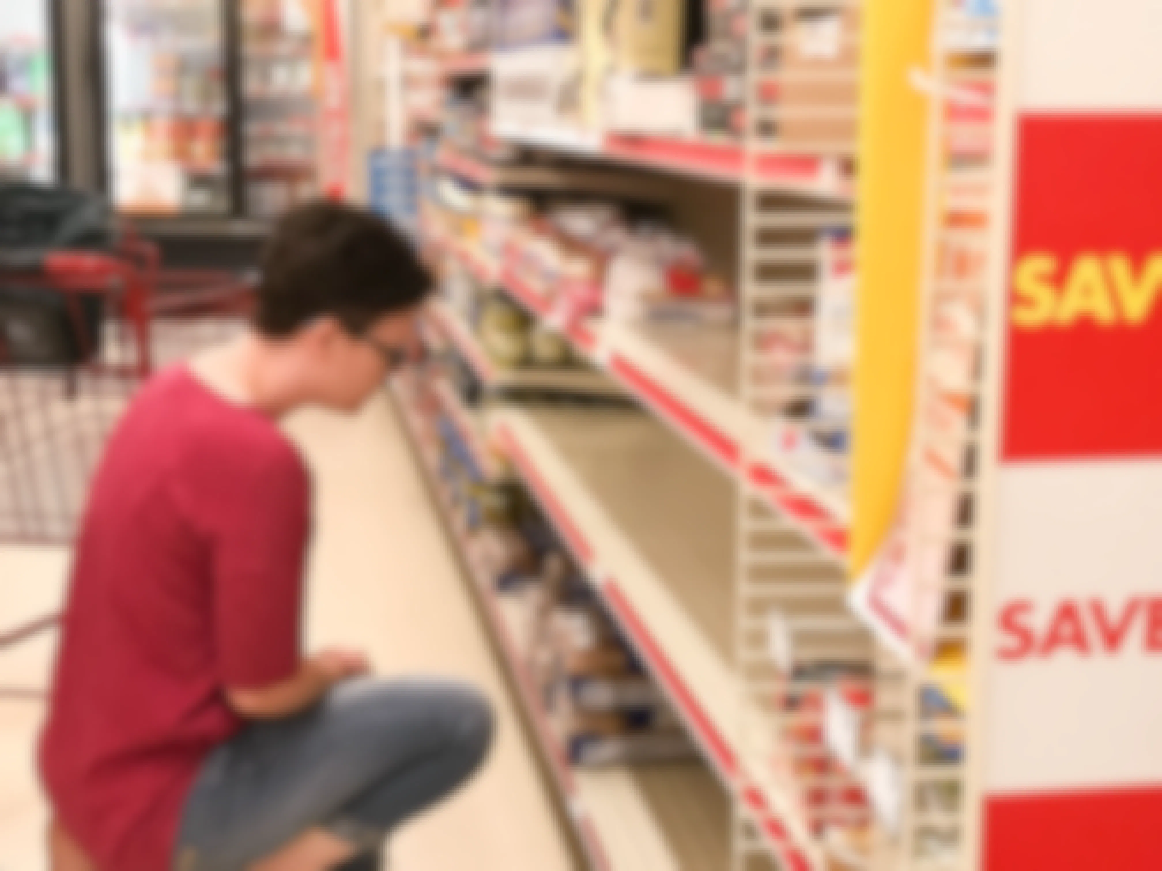 Woman looking at an almost empty Family Dollar shelf