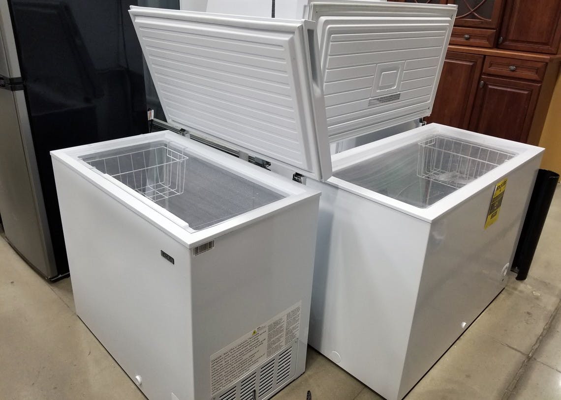Two chest freezers open, side-by-side.
