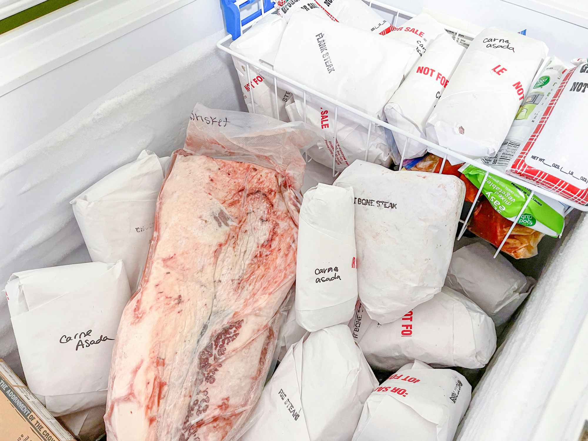 A freezer filled with steaks and beef from a cow.
