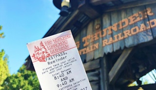 A fastpass reminder ticket for Big Thunder Mountain Railroad in front of the ride's entrance at Disneyland.