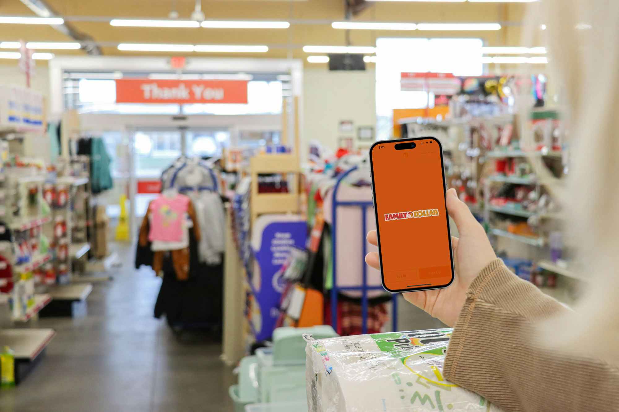 a person holding up a phone in the family dollar