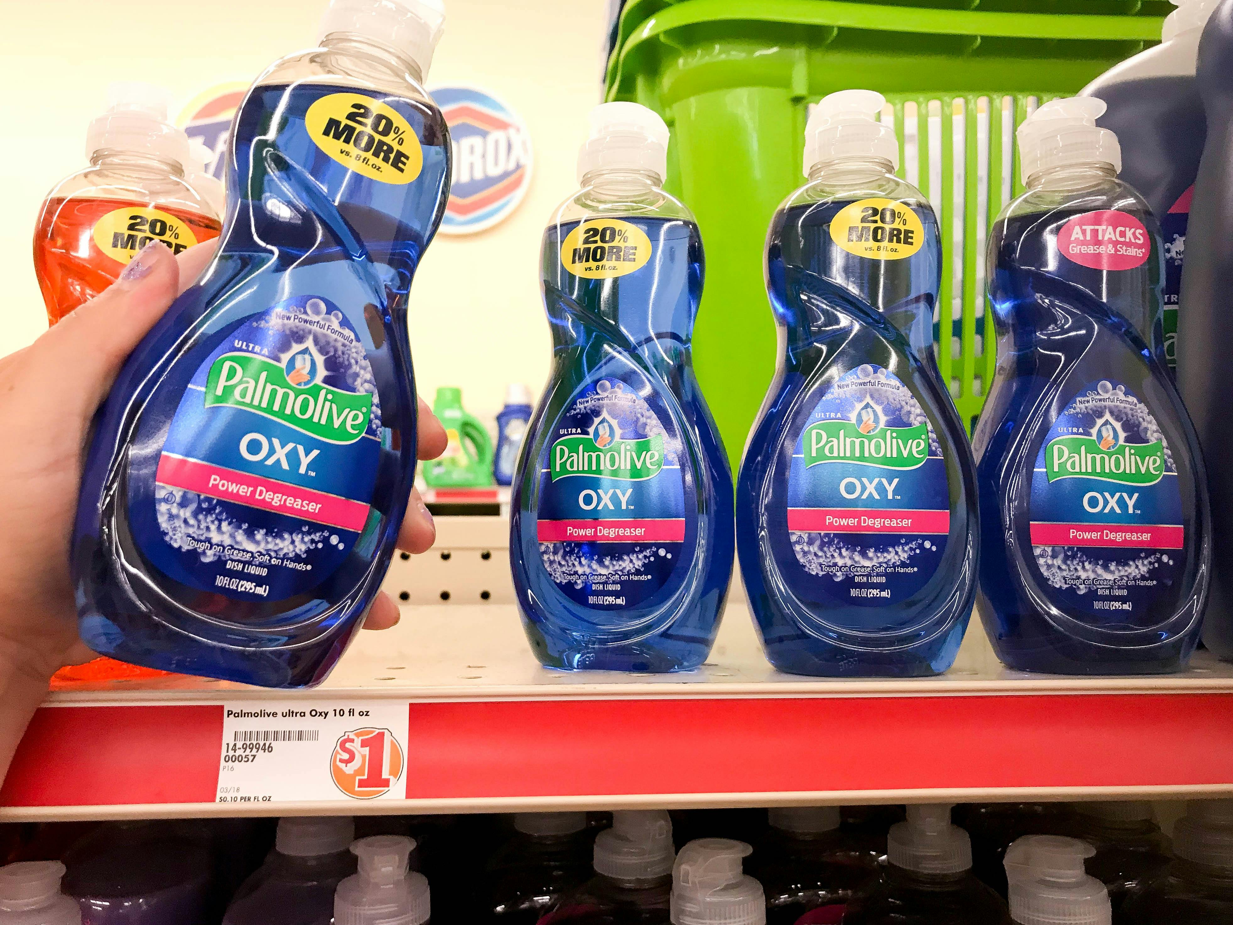 Woman pulling dish soap from a shelf with $1 price tag label