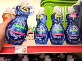 Woman pulling dish soap from a shelf with $1 price tag label