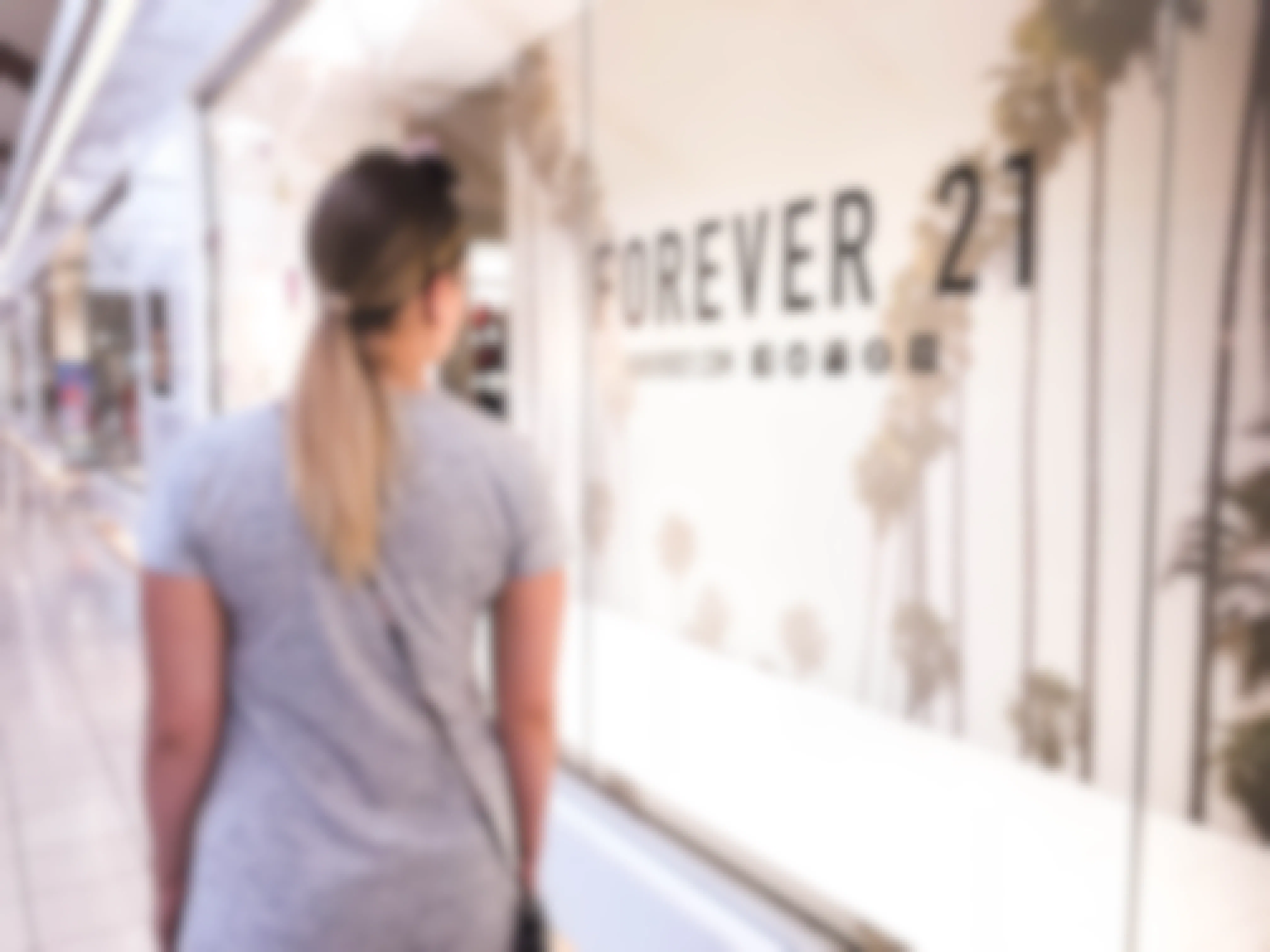 A woman walking by a Forever 21 store location.