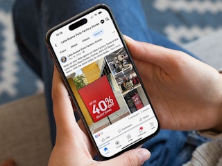 Someone looking at a Facebook post from a local outlet mall advertising their Nike Factory Outlet sale