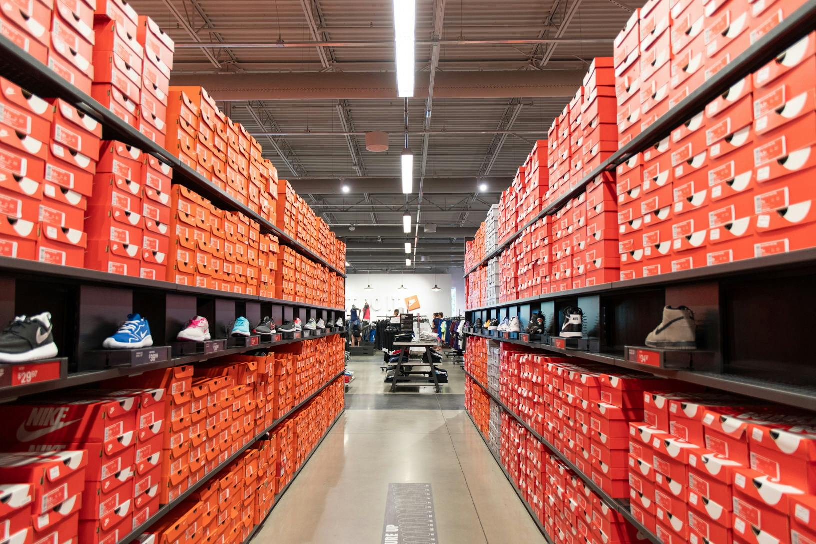 shelves at a nike store filled with cheap nike shoes