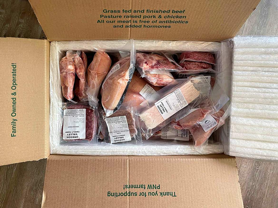 various cuts of oregon valley farm meat wrapped ad placed in shipping box