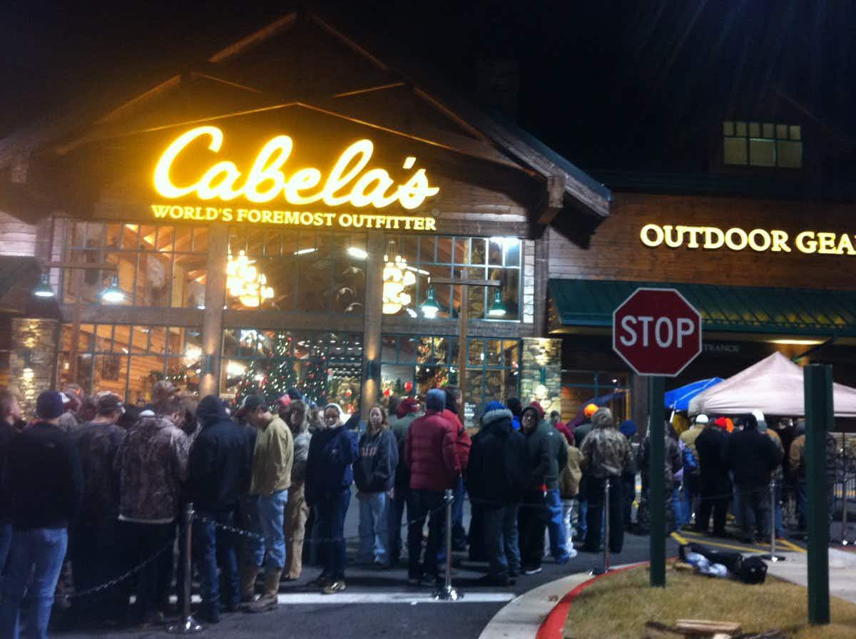 A crowd of people gathered outside the entrance to Cabela's.