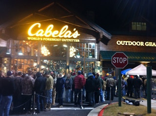 A crowd of people gathered outside the entrance to Cabela's.