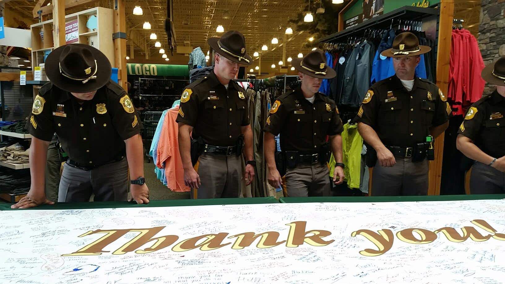 A group of law enforcement standing inside a Cabela's store.