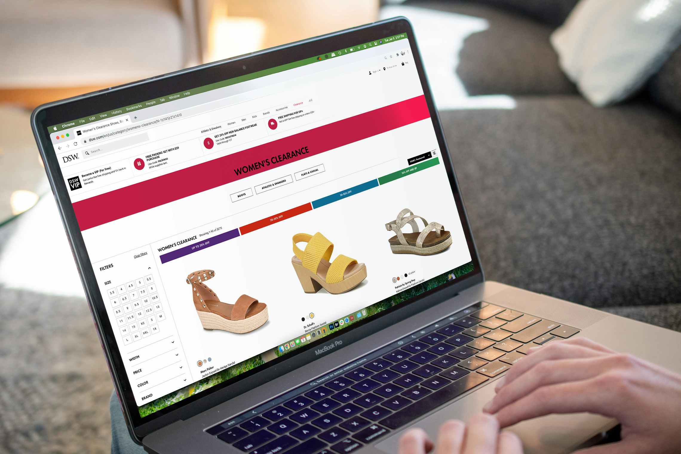 Person on a computer, online shopping for clearance shoes from DSW.com