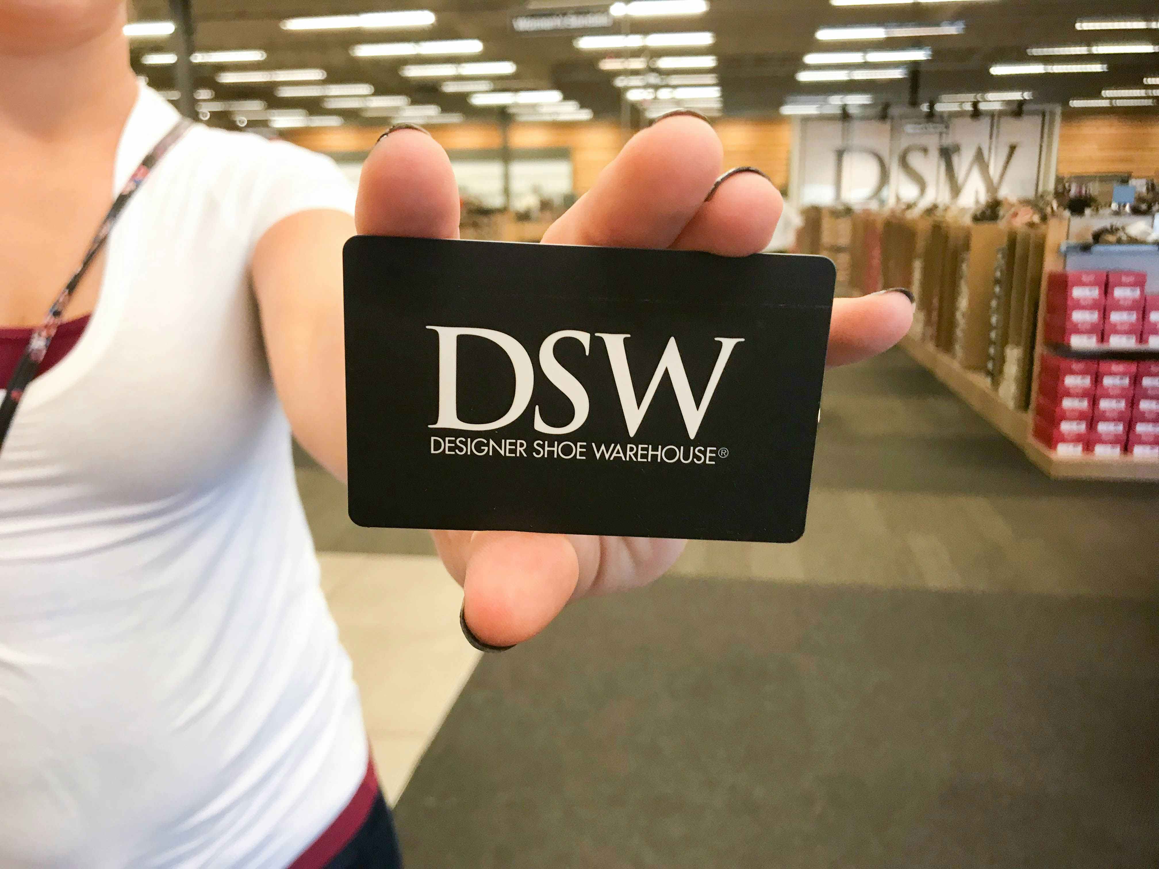 someone holding a dsw gift card in dsw