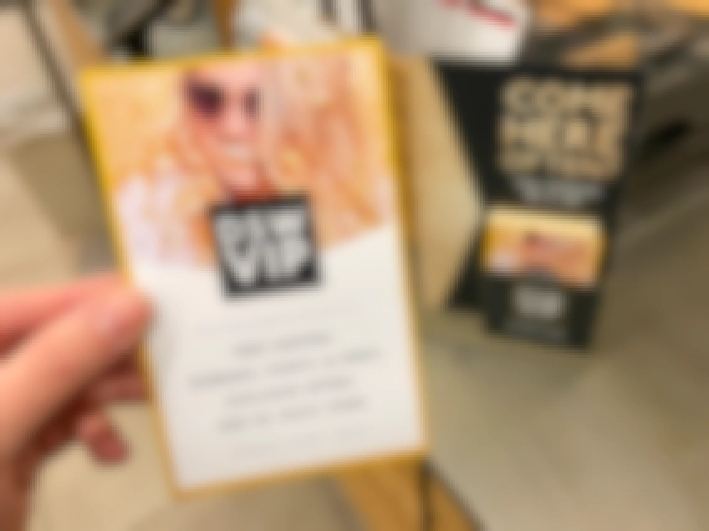 A person holding up a DSW VIP info card near checkout.