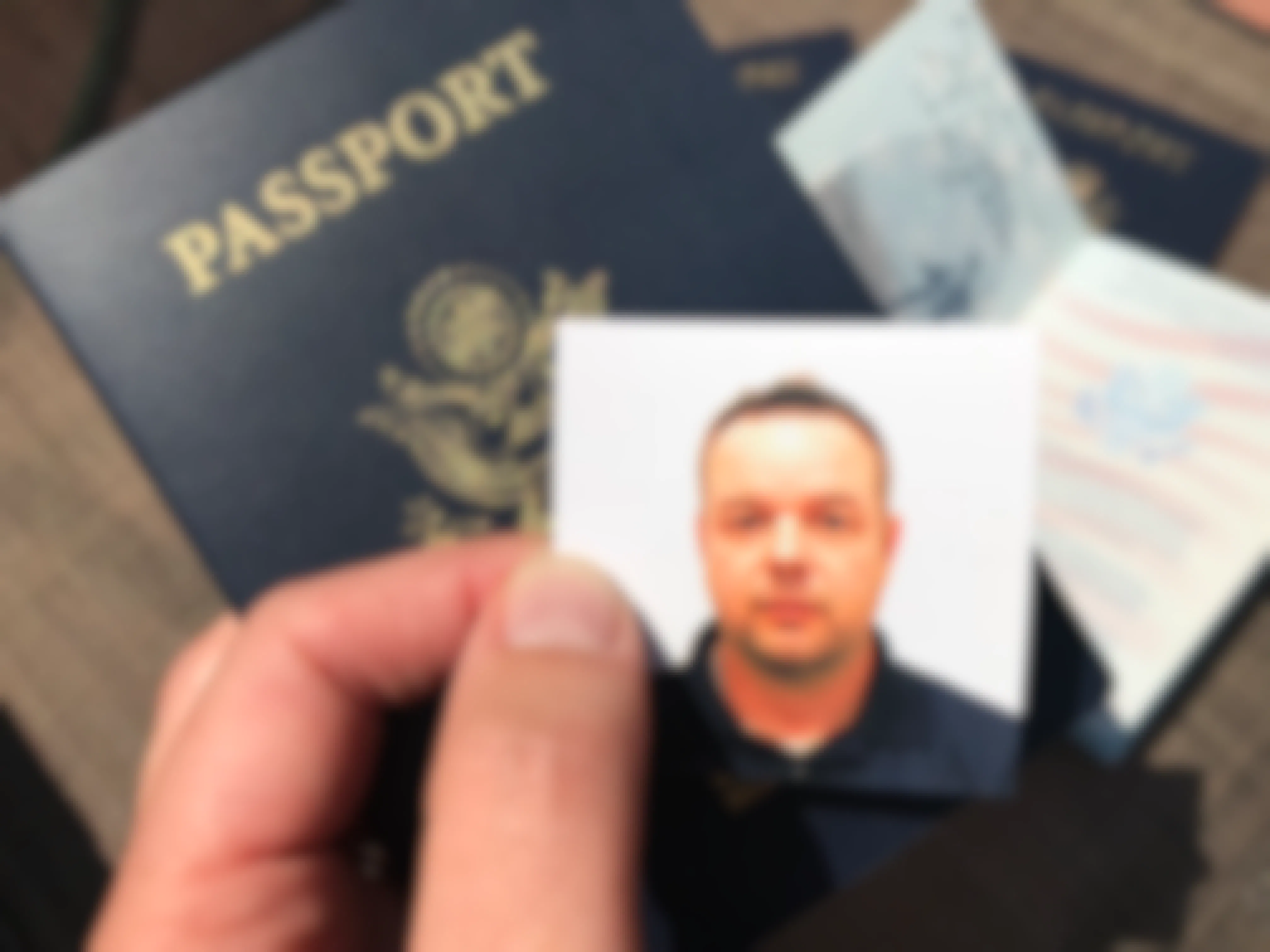 A Passport photo in front of a Passport booklet
