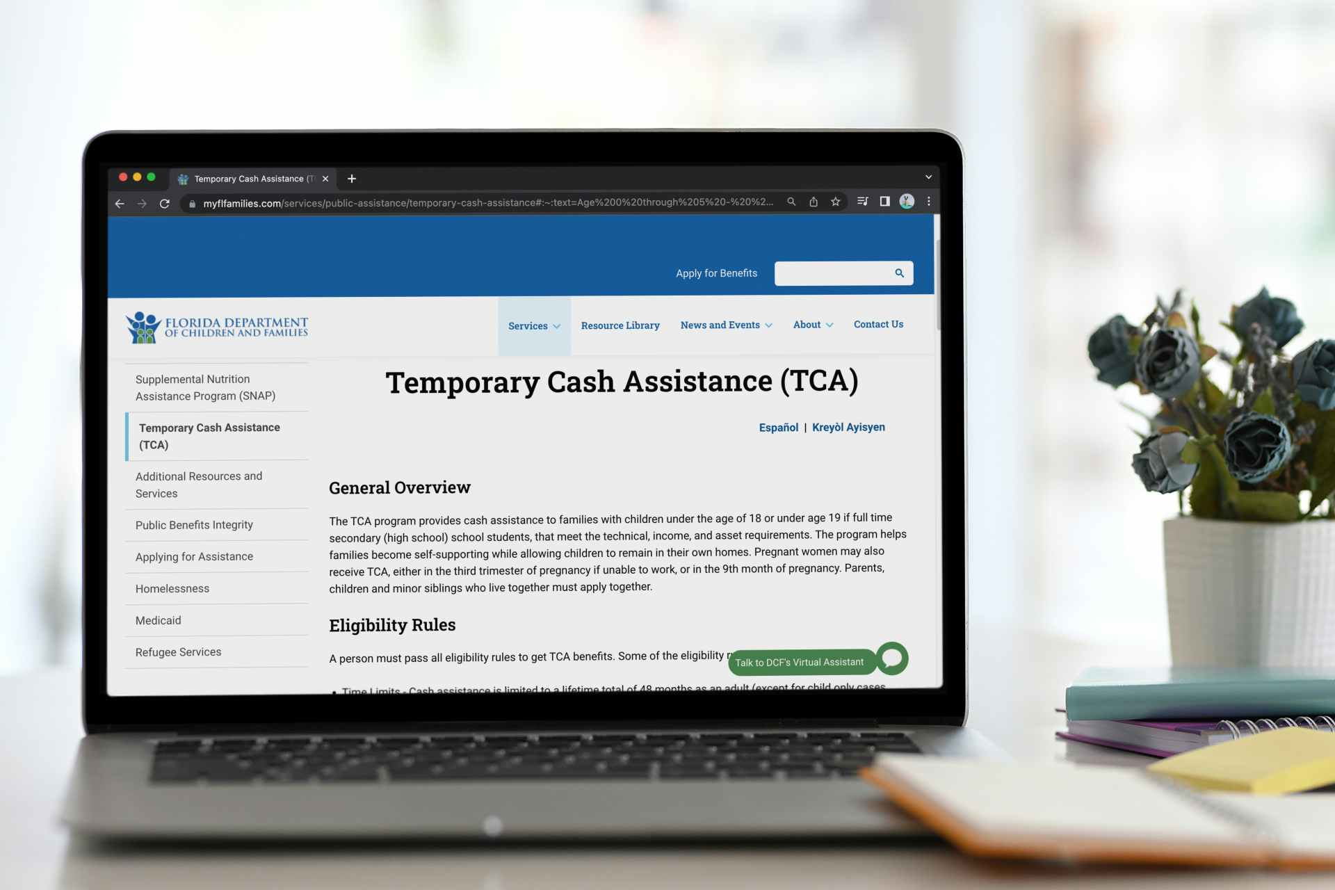A website to apply for Temporary Cash Assistance benefits on a laptop