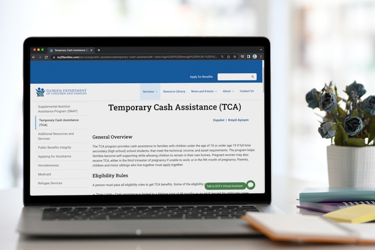 A website to apply for Temporary Cash Assistance benefits on a laptop