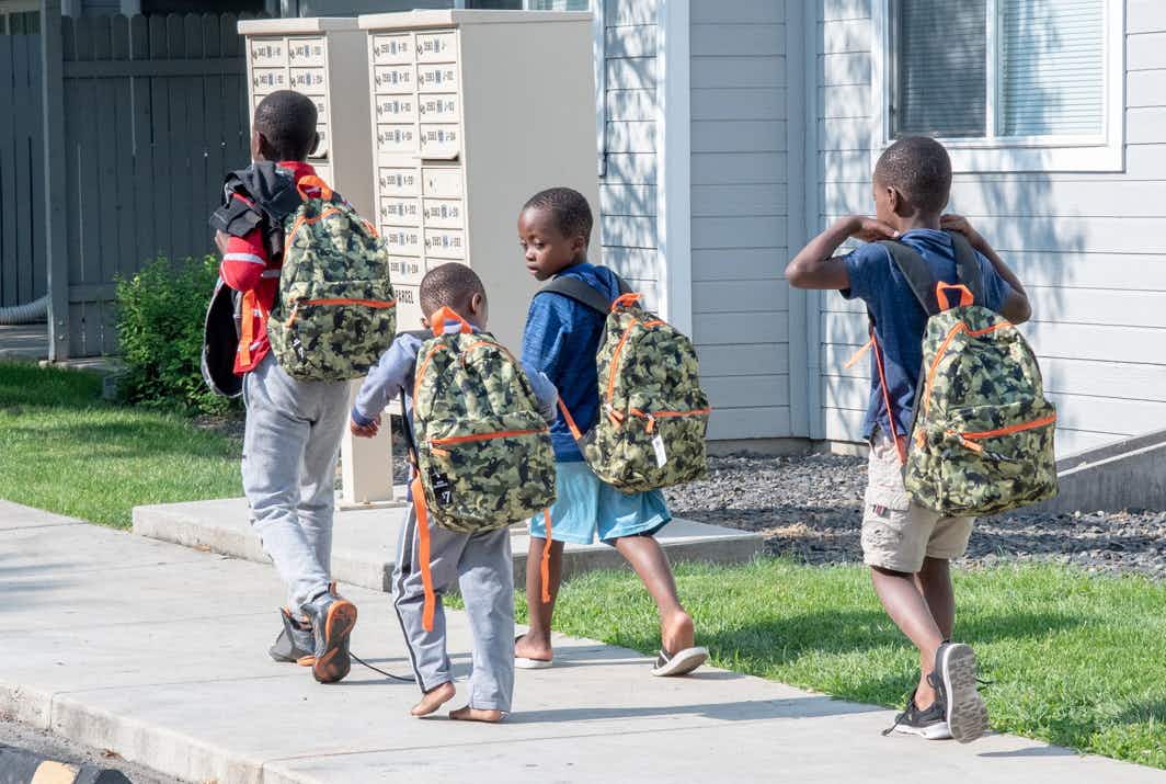 school aged boys wearing backpacks