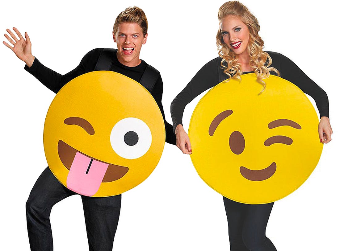 Two people dressed as emojis for Halloween on a white background.
