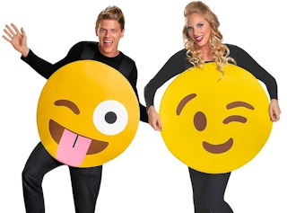 Two people dressed as emojis for Halloween on a white background.