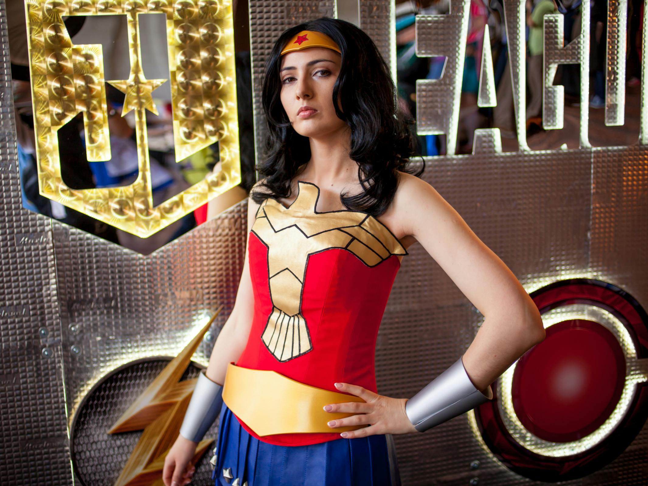 A person dressed as Wonder Woman posing heroically.