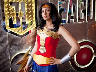 A person dressed as Wonder Woman posing heroically.