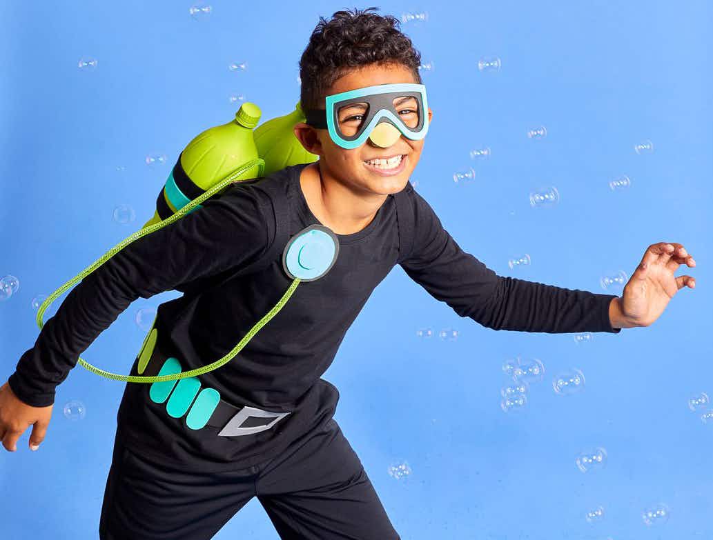 A boy dressed as a scuba diver on a blue background