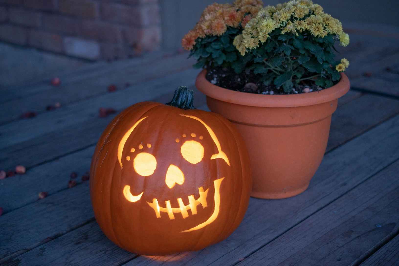 A carved pumpkin sitting on a porch.