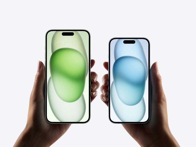 two hands holding up the new iphone 15