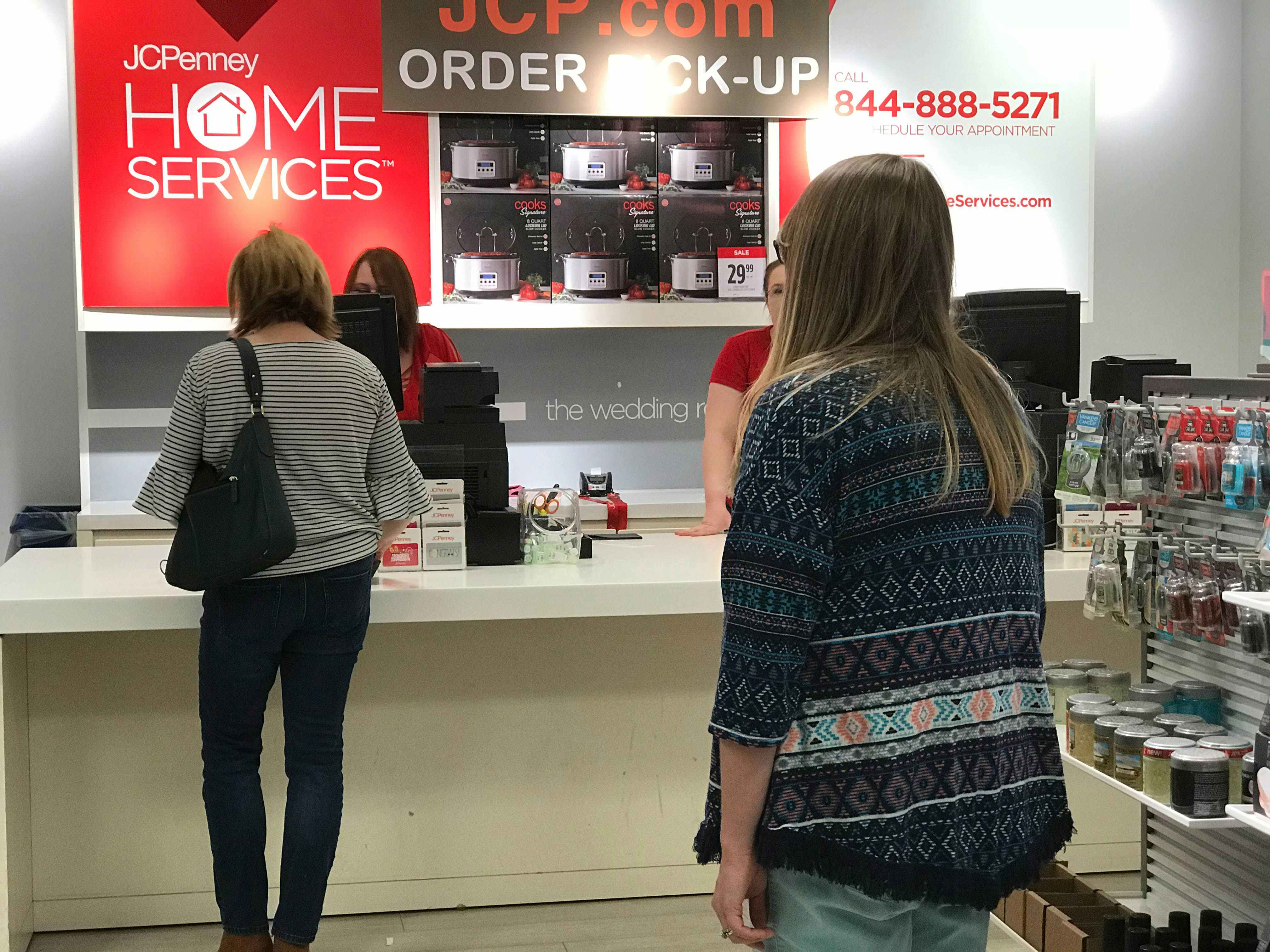 A woman standing in line for the JCPenney customer service desk.