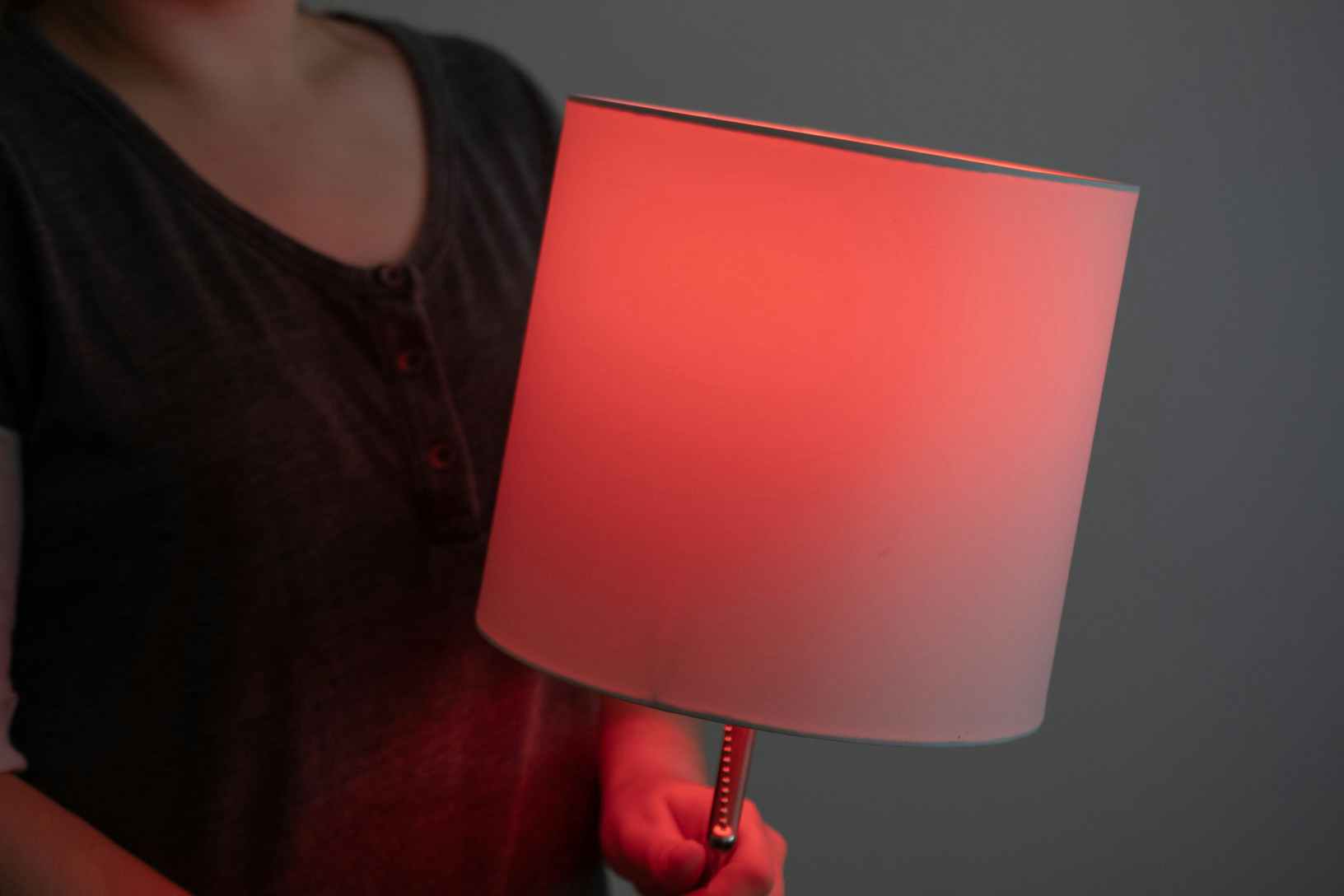 person holding lamp with red light