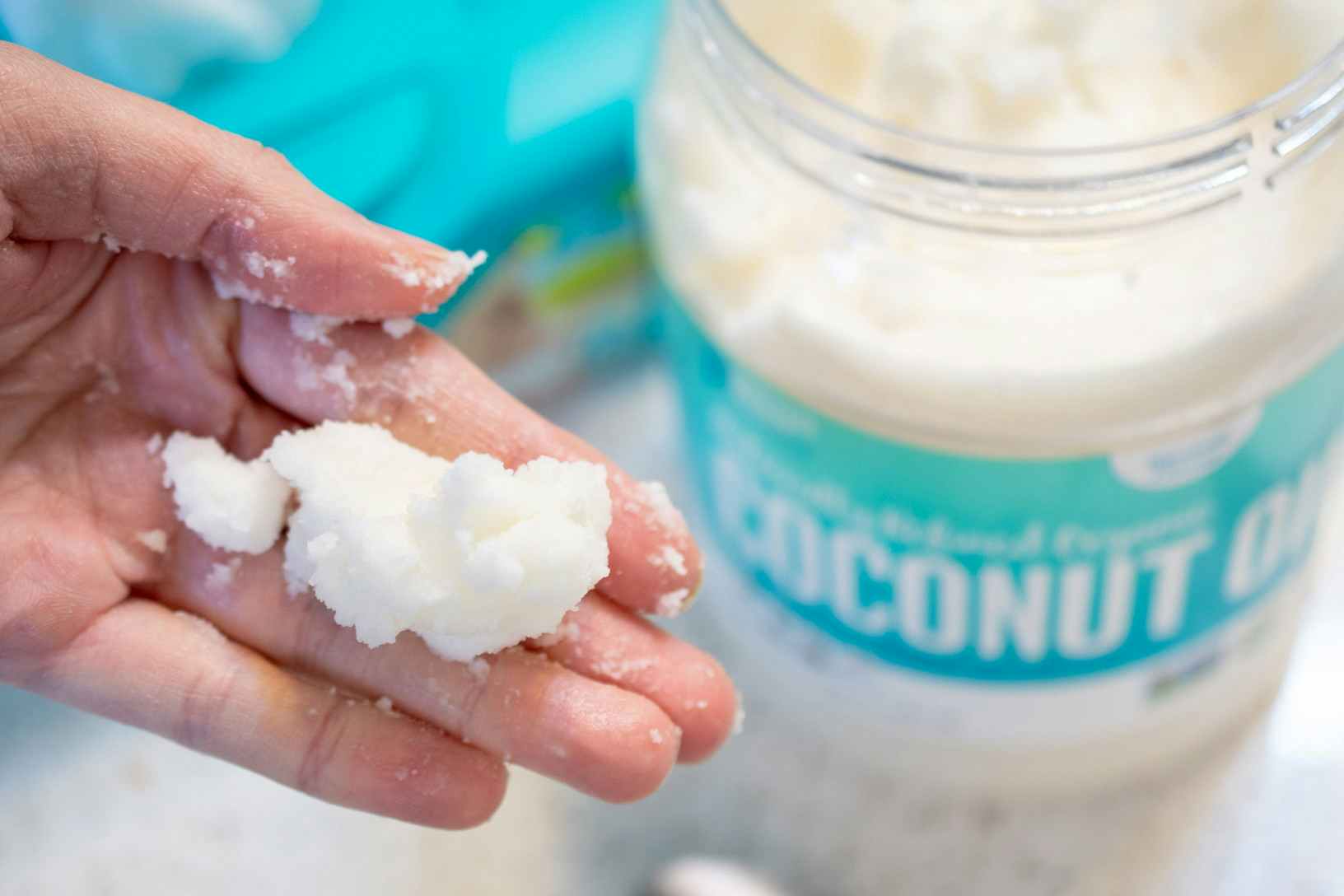 person holding coconut oil in hand