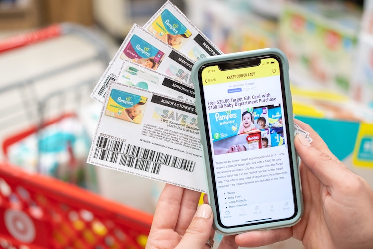 someone holding phone with kcl app and coupons
