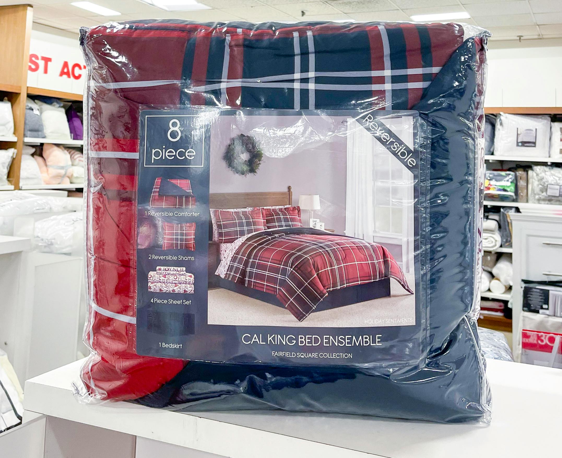 An 8-piece red and blue comforter set on a shelf at Macy's.