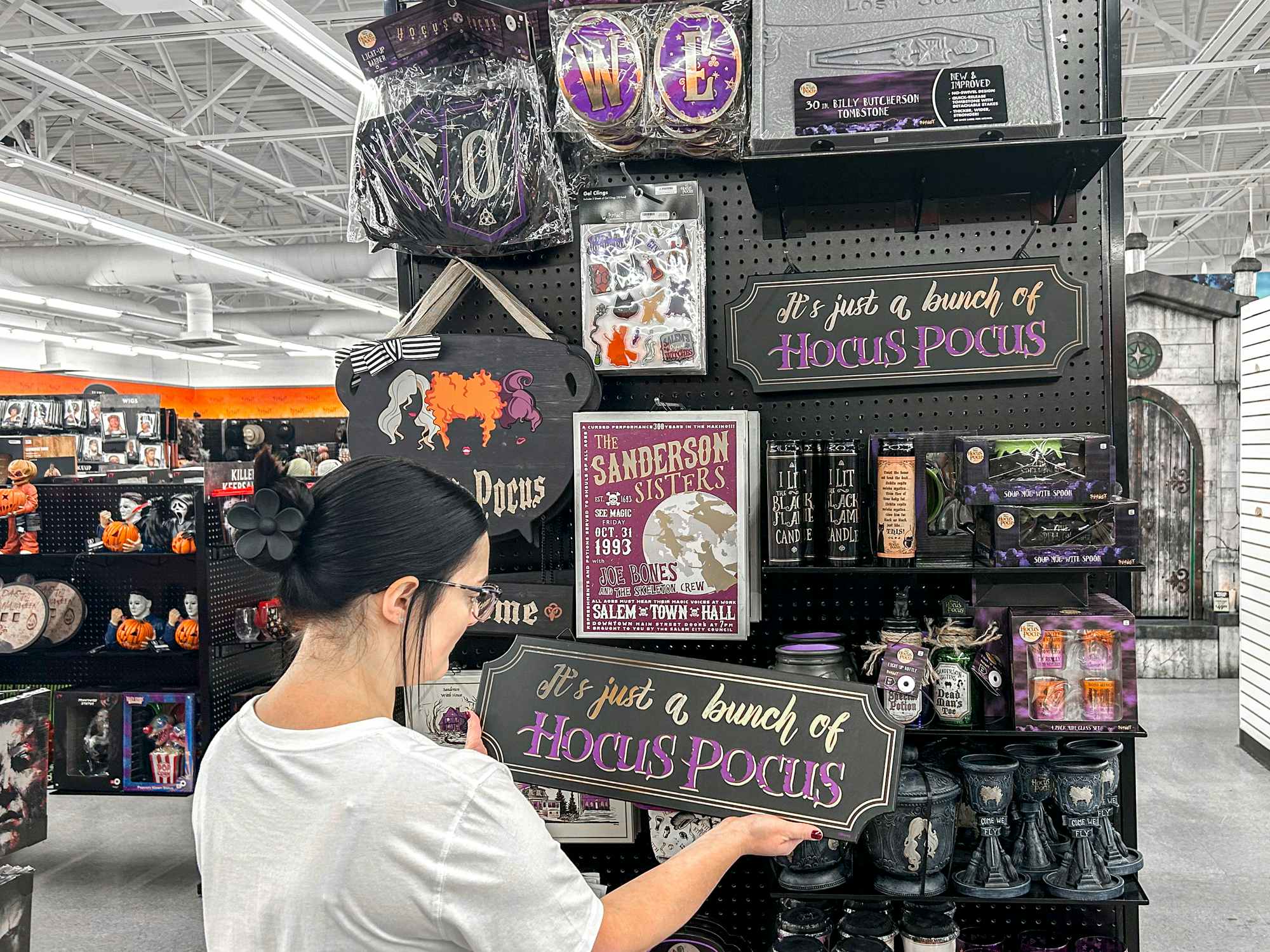 a person looking at the hocus pocus section in spirit halloween 
