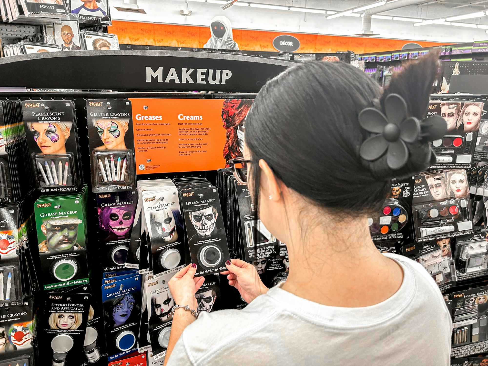 a person looking at makeup at spirit halloween 
