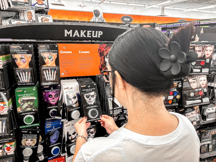 a person looking at makeup at spirit halloween 