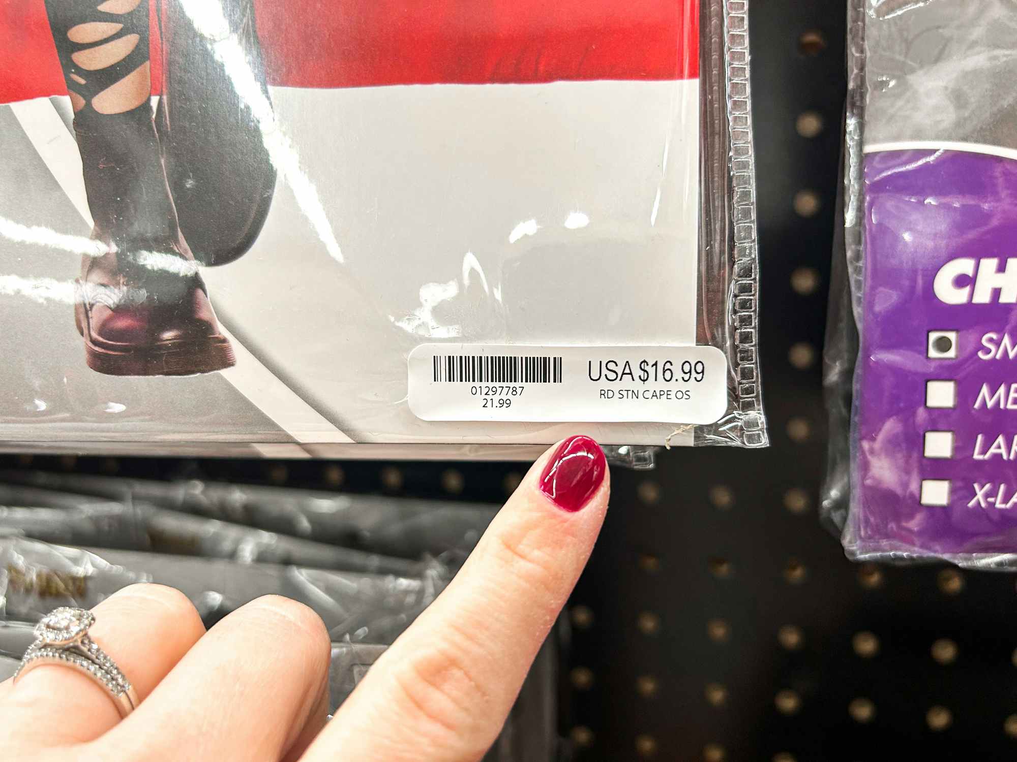 a person pointing to a price tag on a spirit halloween costume 
