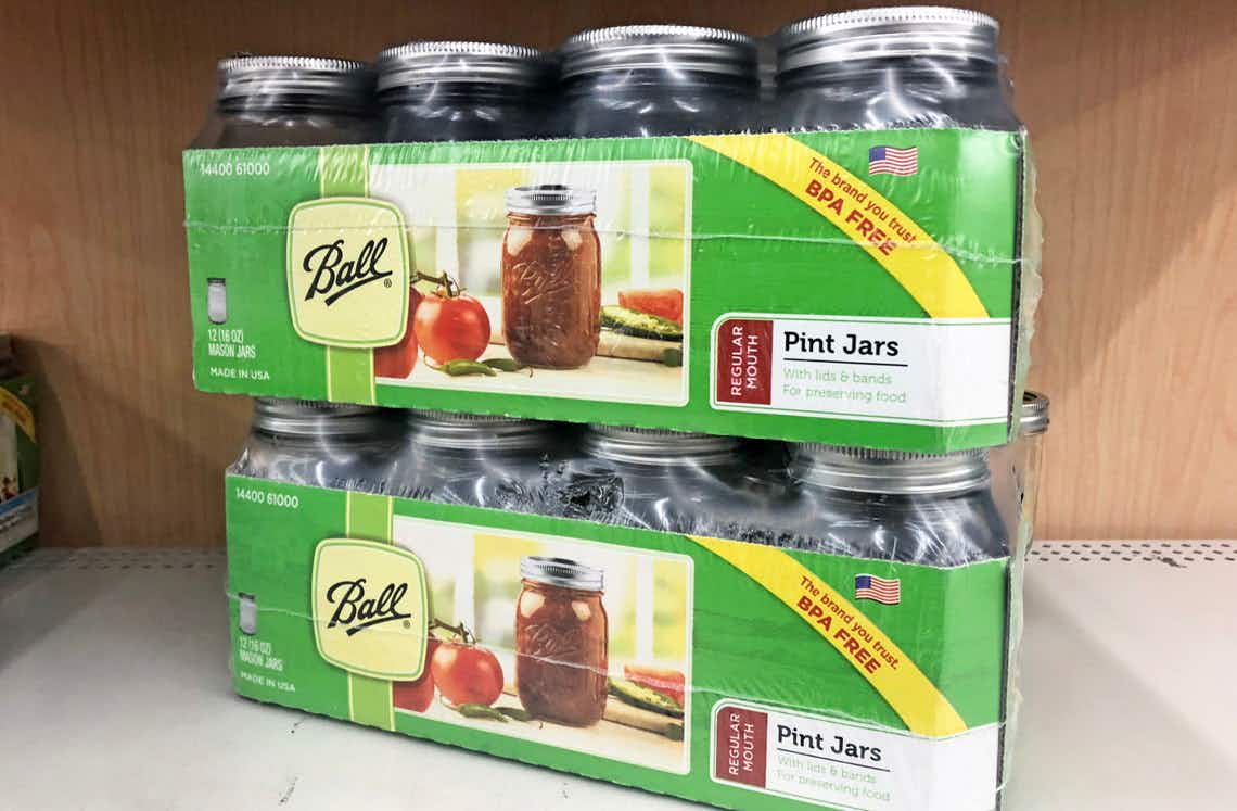 Two cases of Ball canning jars stacked on a store shelf.