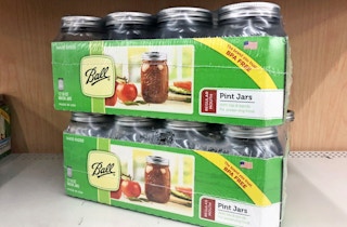 Two cases of Ball canning jars stacked on a store shelf.