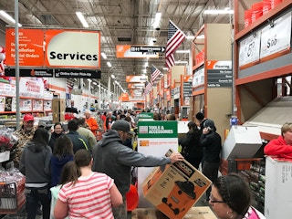 people shopping in a Home Depot store during Black Friday.