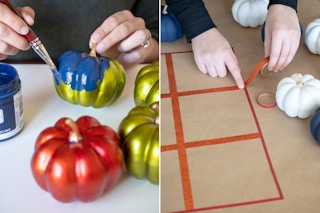 A person painting artificial pumpkins with chalk paint and using washi tape to make a tic-tac-toe board.