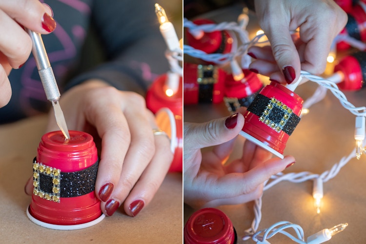 someone cutting out the bottom of small red solo cups and putting lights in them