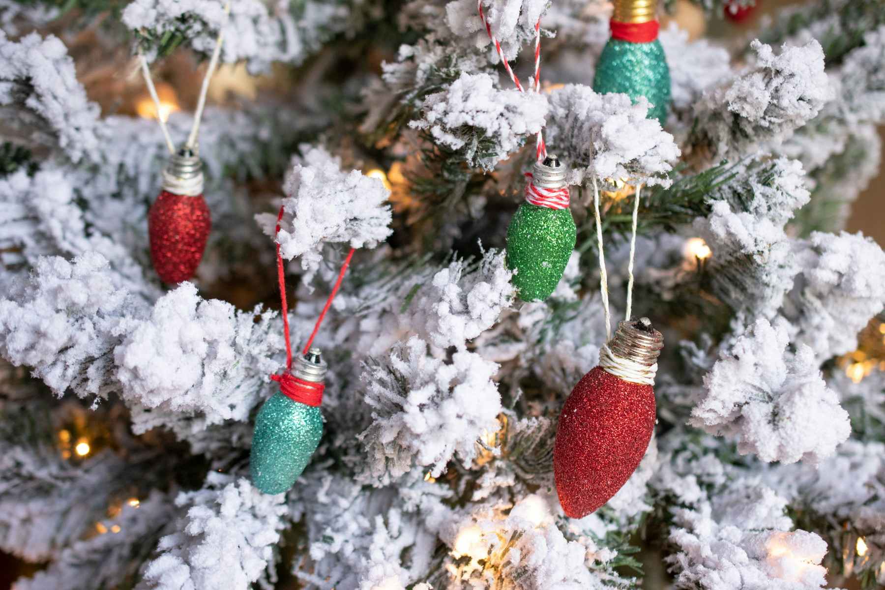 glitter covered bulbs hanging on a Christmas tree
