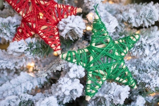 wooden star with string wrapped on it on a tree