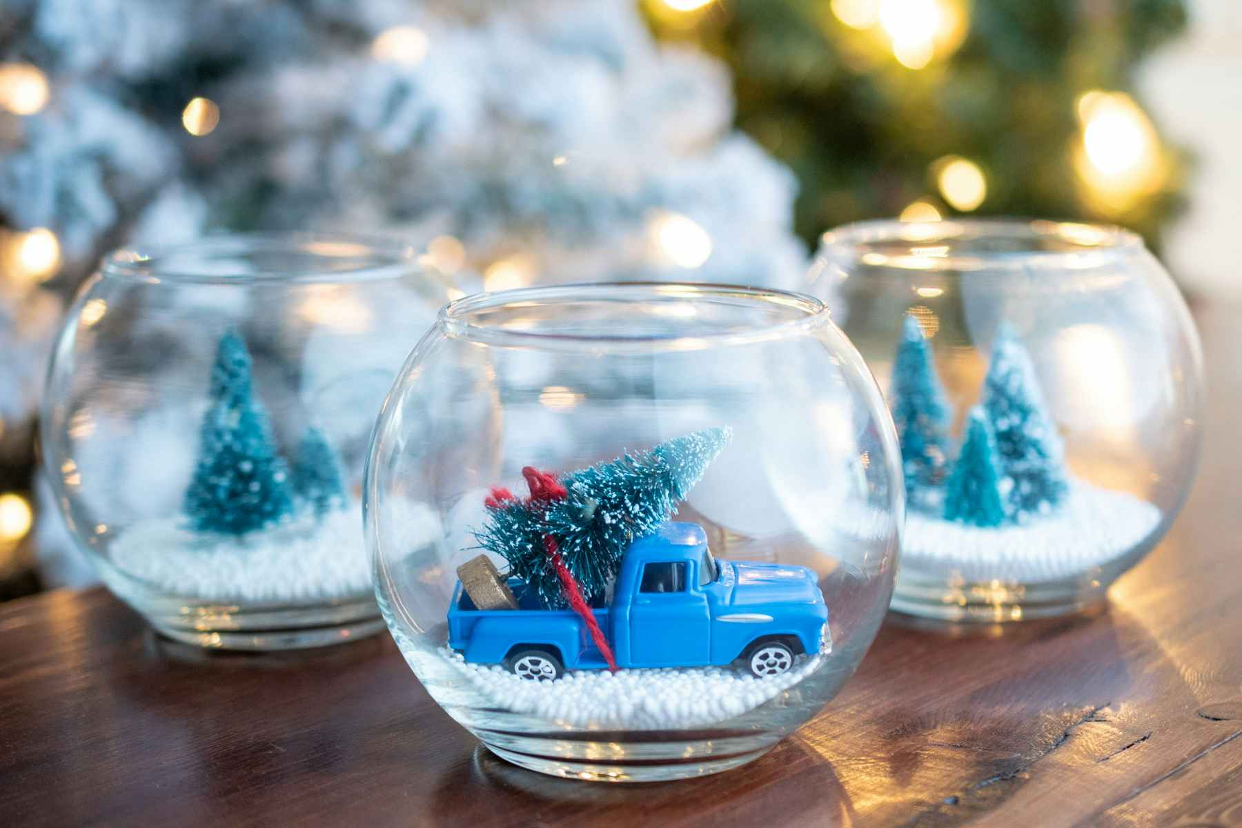 small glass with toy truck and tree in it
