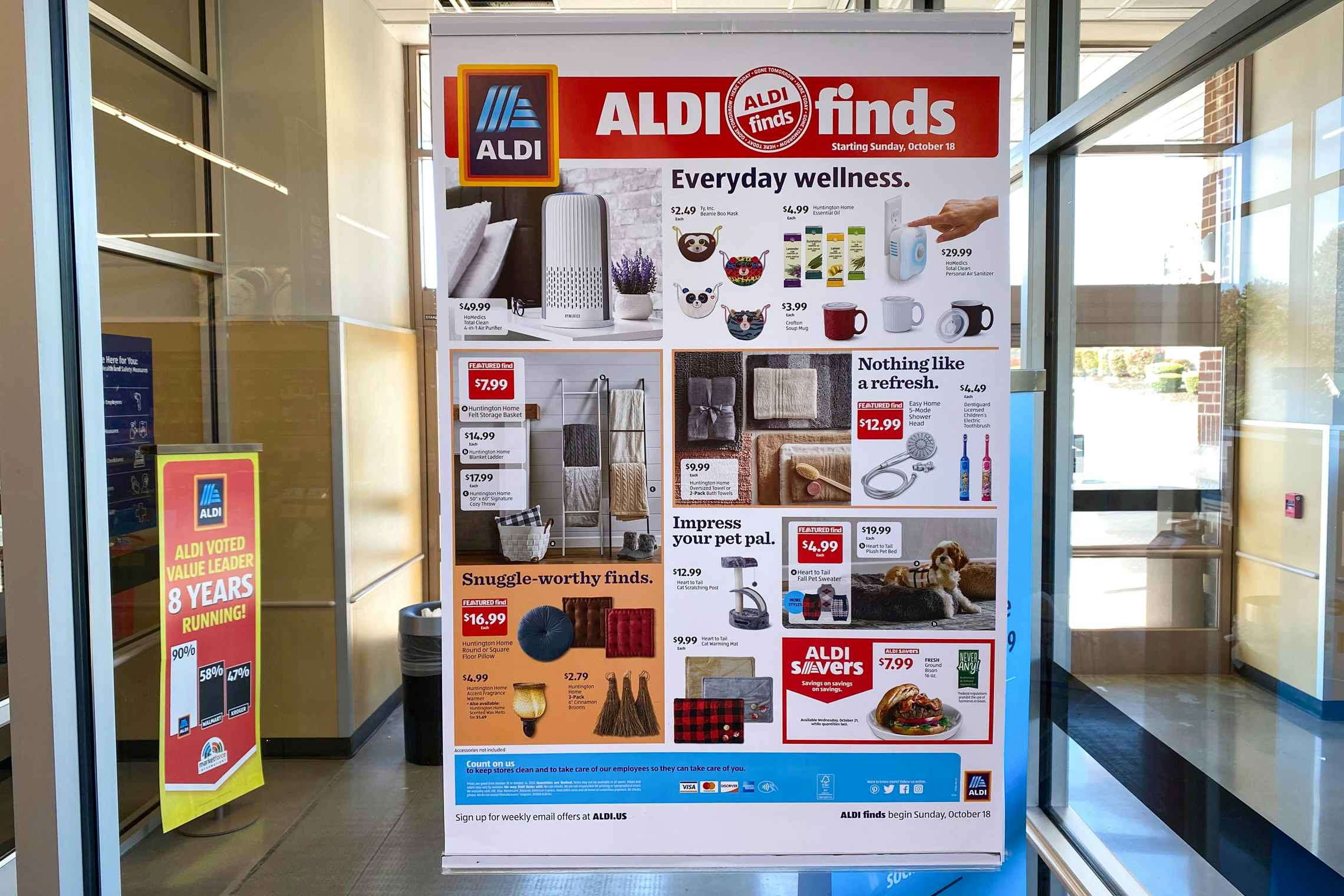 An Aldi Finds poster in the window at Aldi.